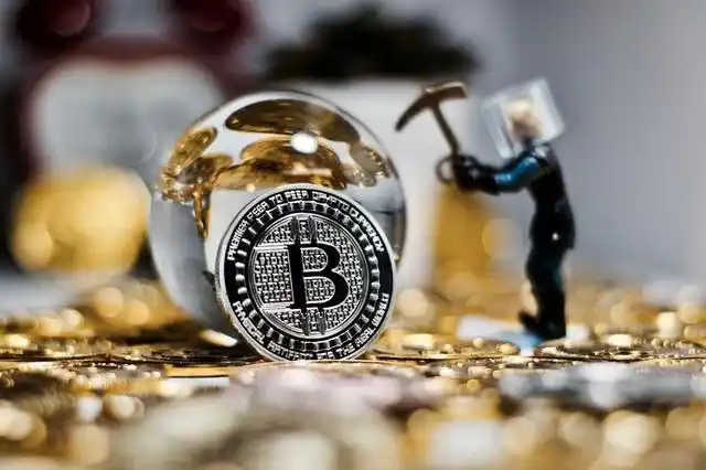 An aerial view of a large-scale Bitcoin mining farm, showcasing the rows of buildings and the scale of the operation