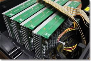 A close-up of a sophisticated mining rig with LEDs glowing